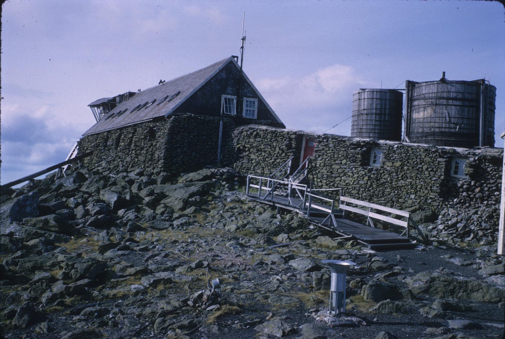 Stone building and wall with water tanks